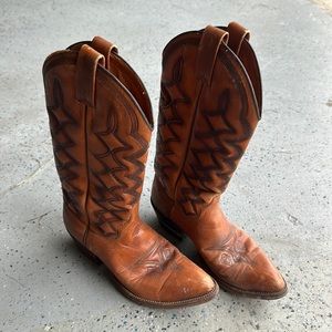 Vintage Dan Post cowboy boots. Worn in. Some scuffs. Small tear on back of left.